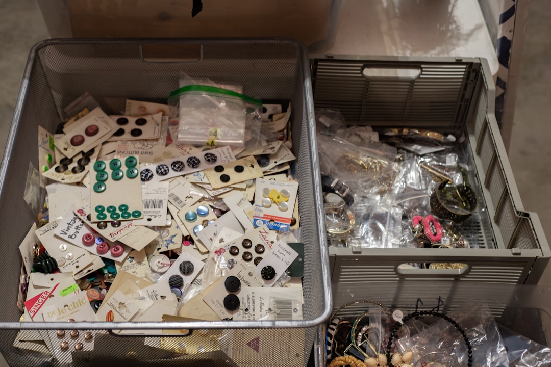 Storage bins filled with assorted sewing buttons and notions