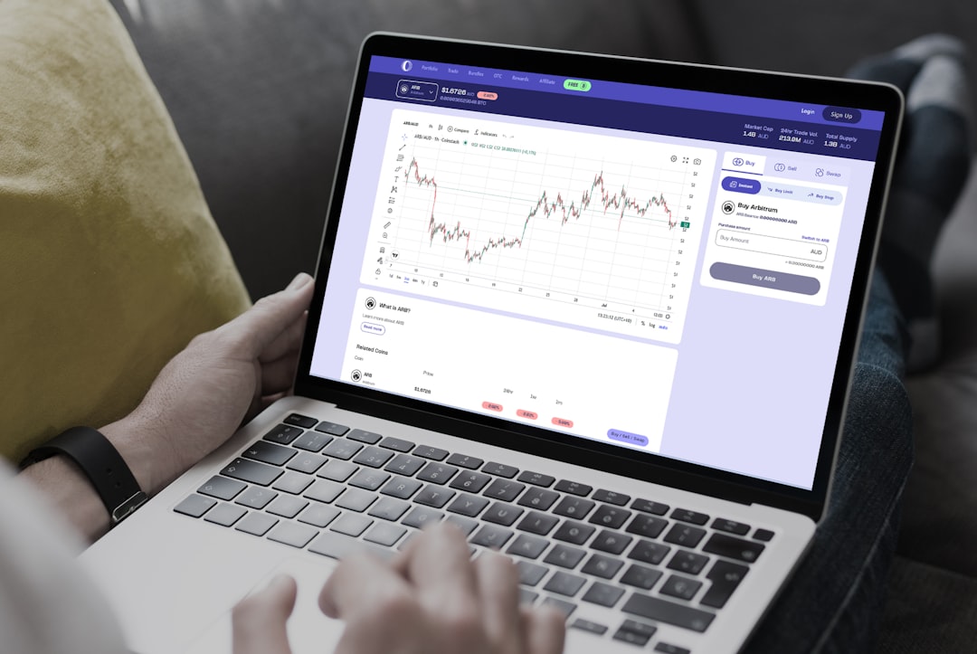 Person using a laptop showing a price chart dashboard
